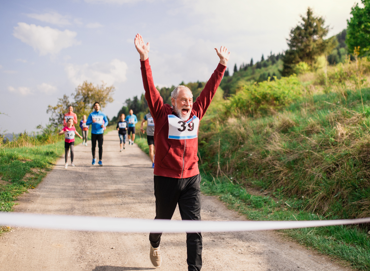 happy mature man running race, healthy habits to live to 100