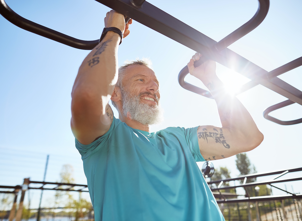 mature man performing workout to build stronger muscles in your 50s