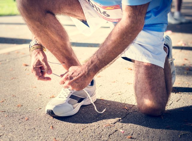 Mature man laces sneakers, runner, healthy habits to live to 100