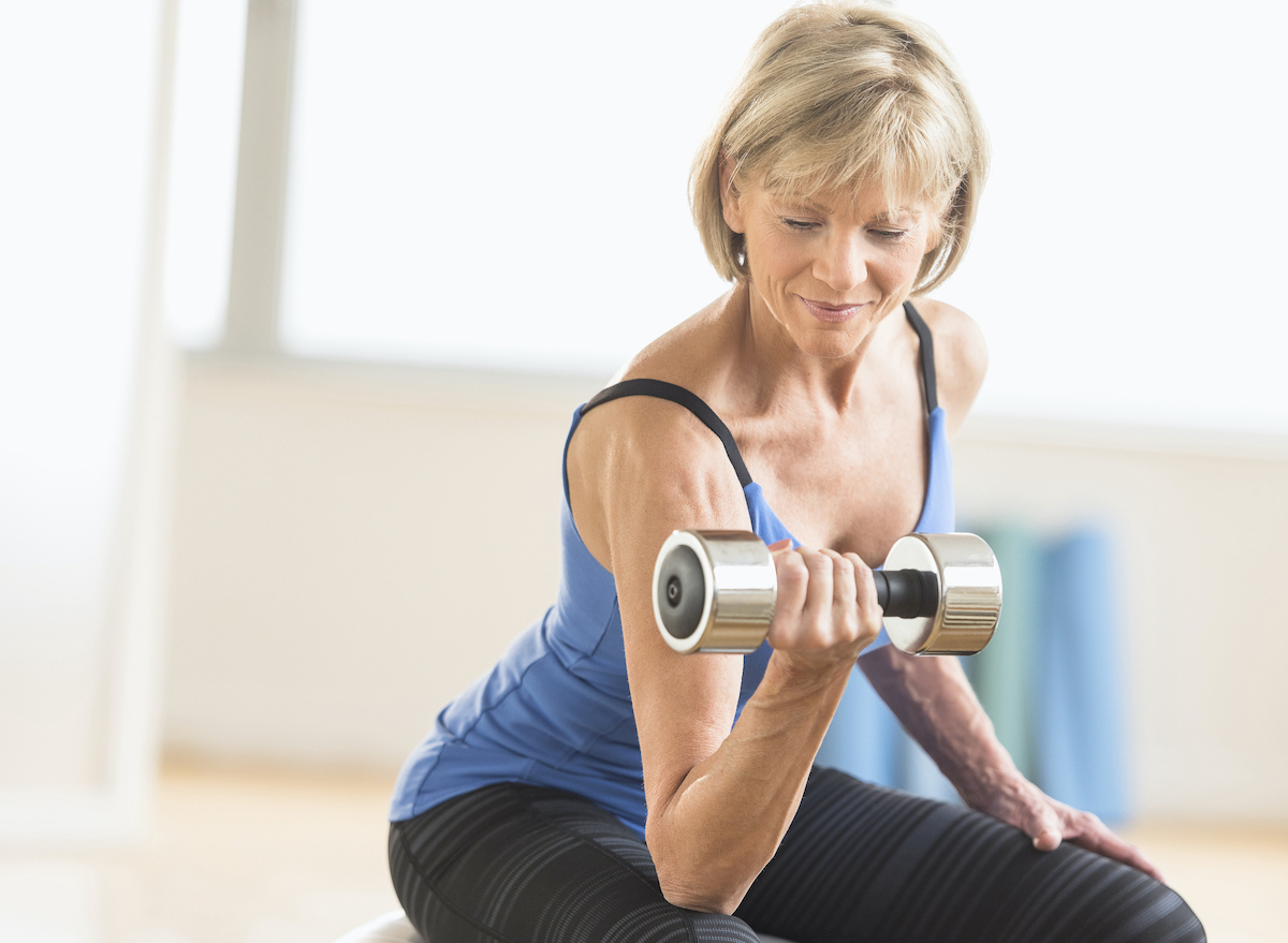 mature woman demonstrating strength training workout to regain muscle mass with age