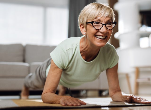 mature woman performing forearm plank