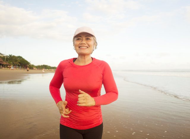 mature woman running on the beach