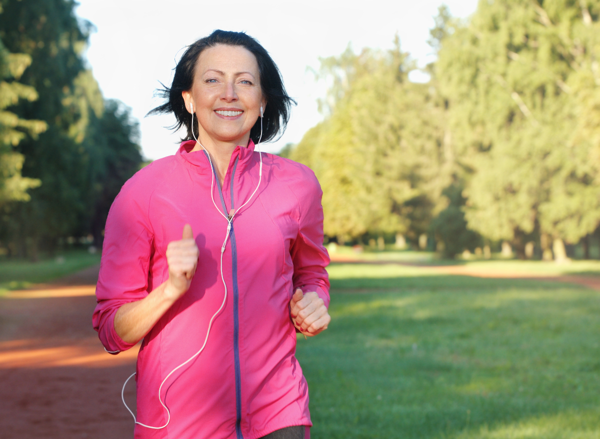 mature woman running cardio outdoors