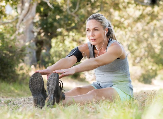 mature woman stretching in park