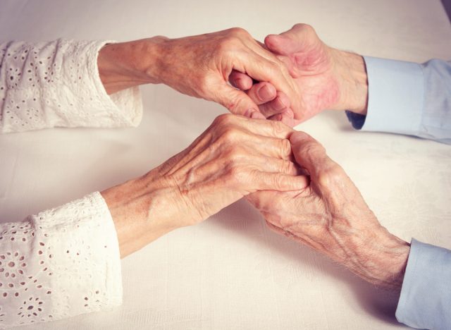 old couple holding hands