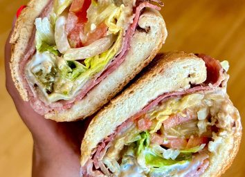 person holding potbelly sandwich