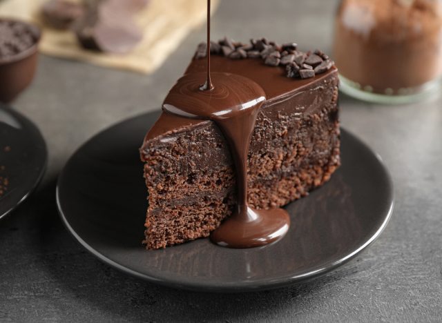 pouring chocolate sauce on chocolate cake