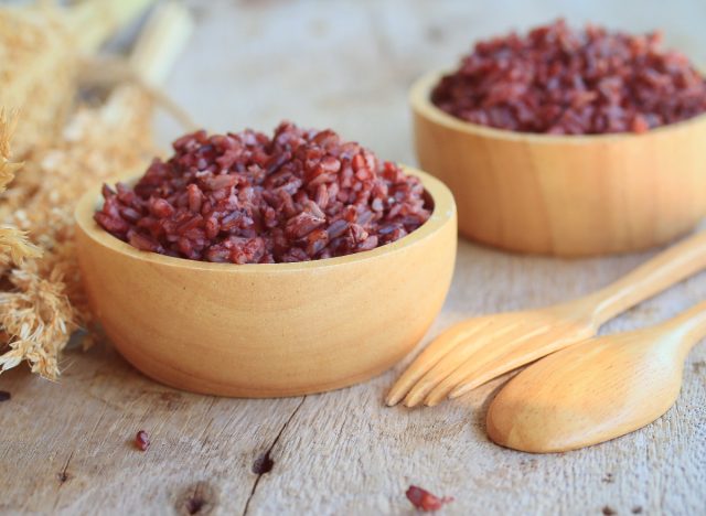 red rice in bowls with fork and spoon