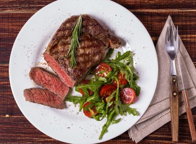 ribeye steak with arugula and tomatoes