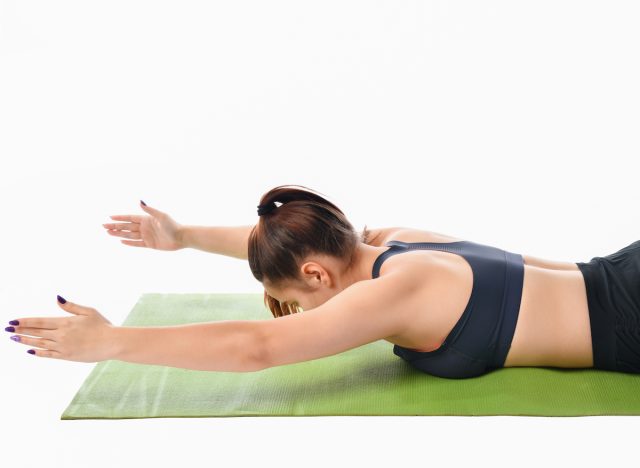 woman performing exercise on stomach