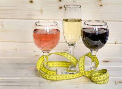 wine glasses, tape measure, demonstrating lower-calorie alcohol swaps