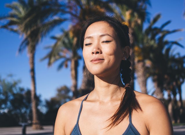 woman doing breathing exercises before workout