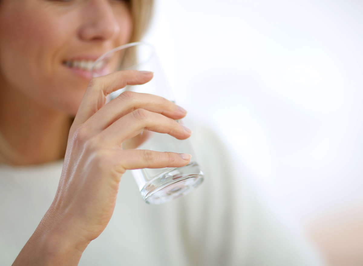 woman drinking water glass