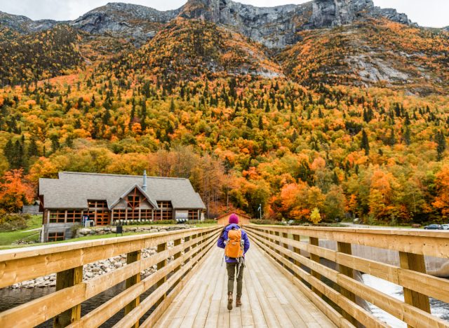 woman hiking to lodging in autumn