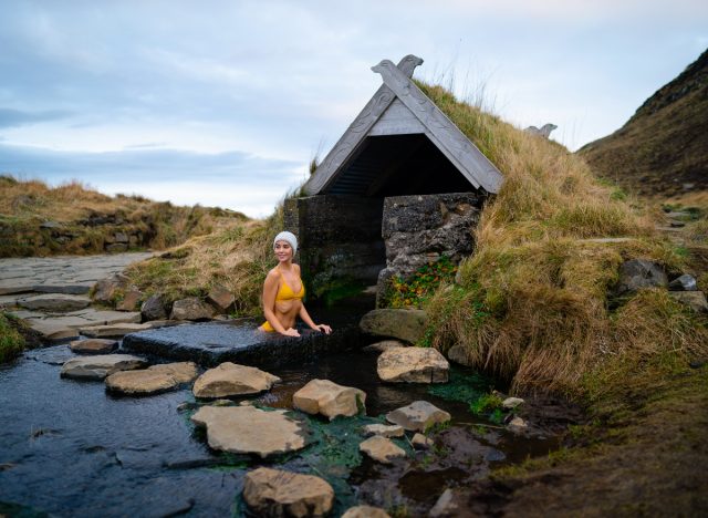woman bathing in Iceland hot springs, demonstrating how to live a simple life in Iceland