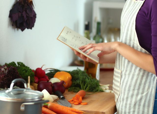 woman reading cookbook