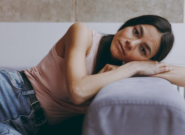 woman, toxic relationship, looking discouraged on couch