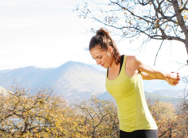 woman stretching arms behind her back