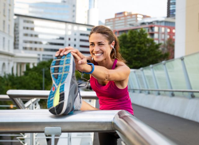 woman stretching doing warm-up before run, demonstrating benefits of running every day