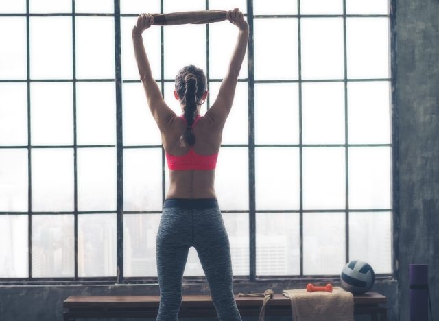 woman performing towel pull down exercise as part of bingo wings workout