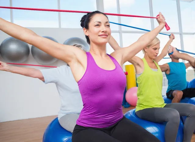 woman working with resistance band in workout class