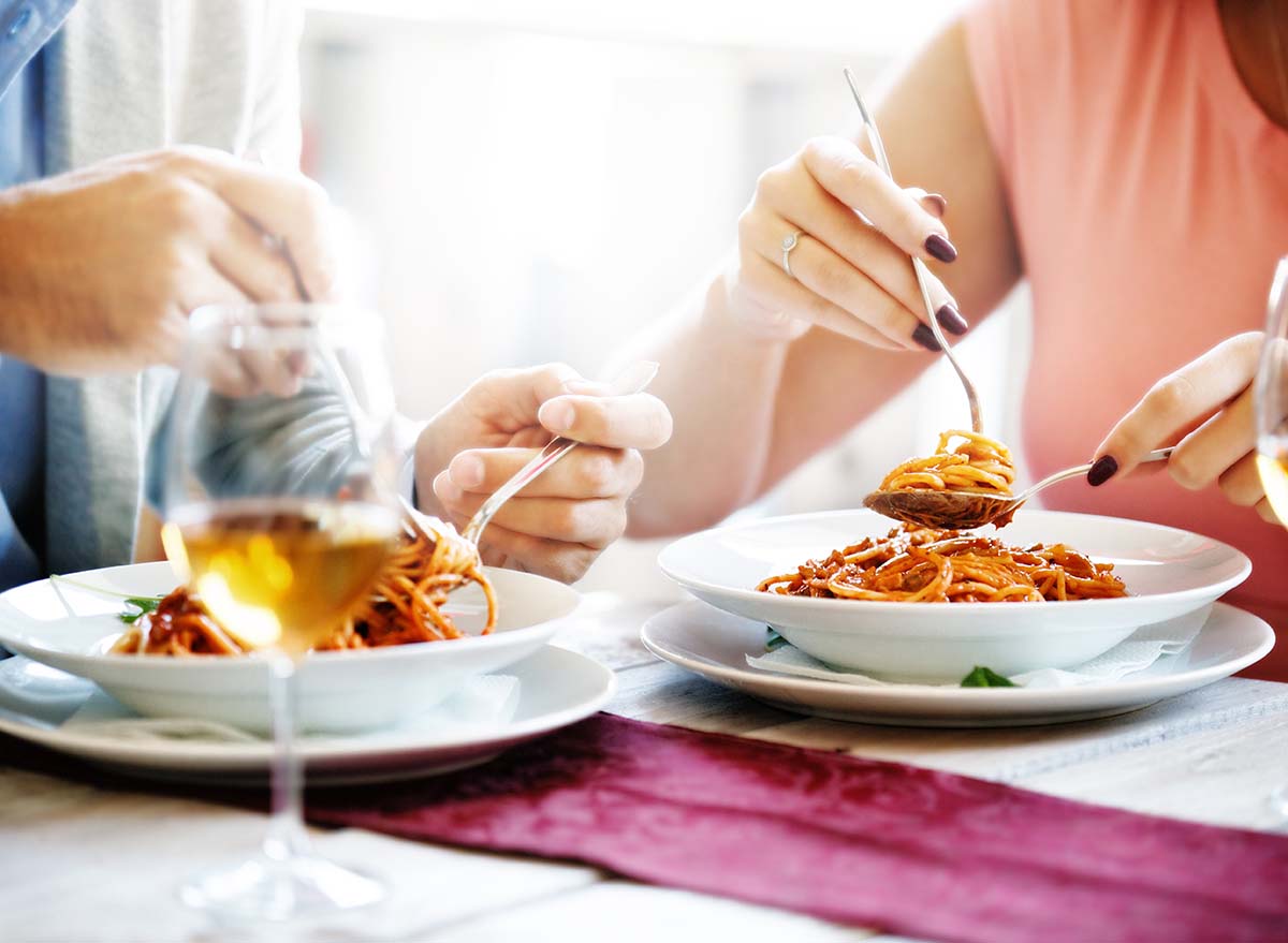 Eating spaghetti with spoon and fork