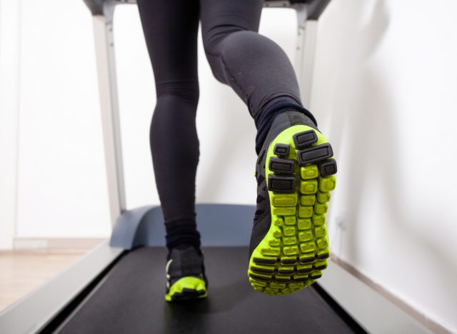 back of woman's legs running on treadmill