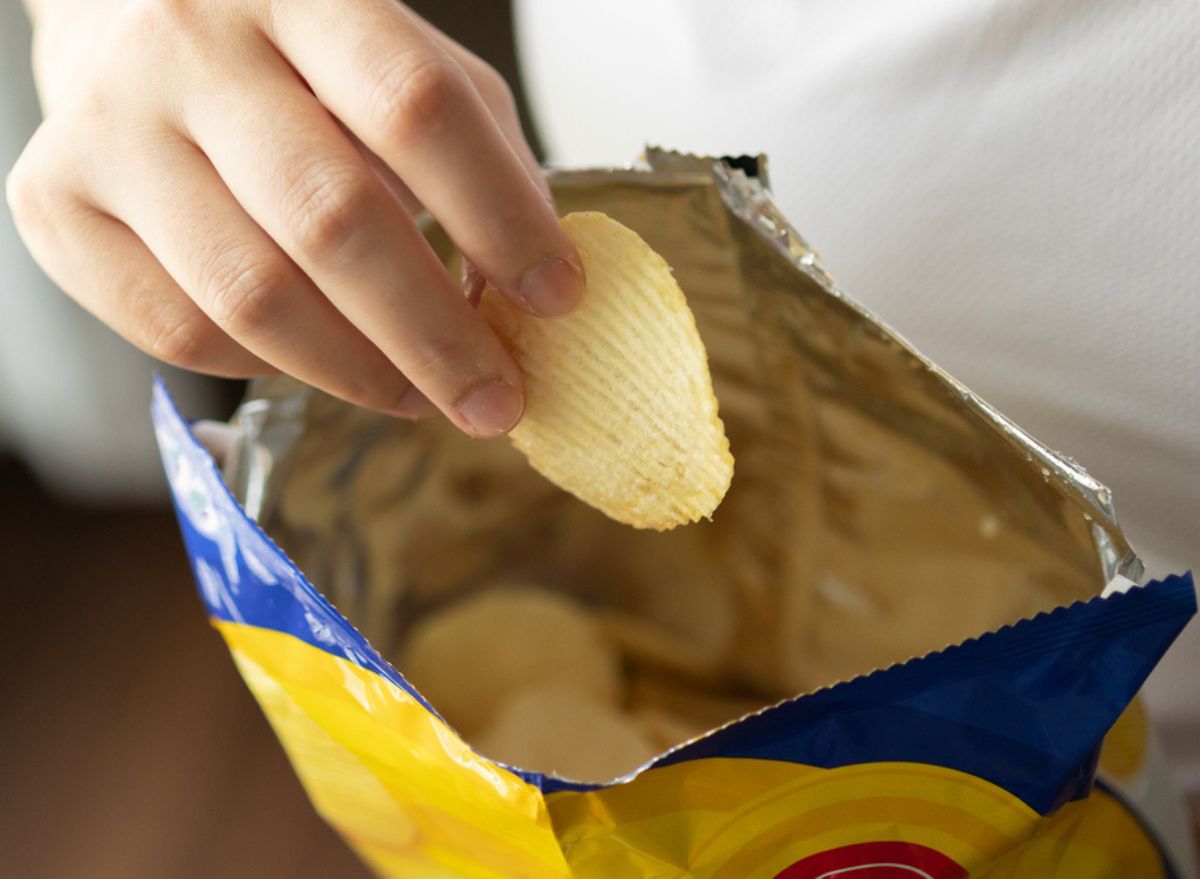 eating from a bag of chips