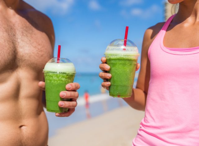 fit couple holding green smoothies on beach, breakfasts for rapid weight loss