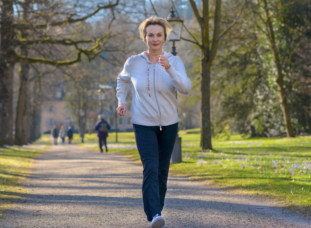 fit, mature woman demonstrating what daily walking habit does to your body