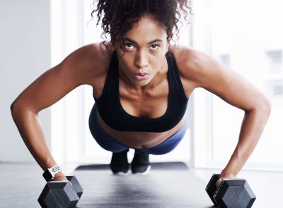 fitness woman performing dumbbell pushups, workout to burn more calories than running