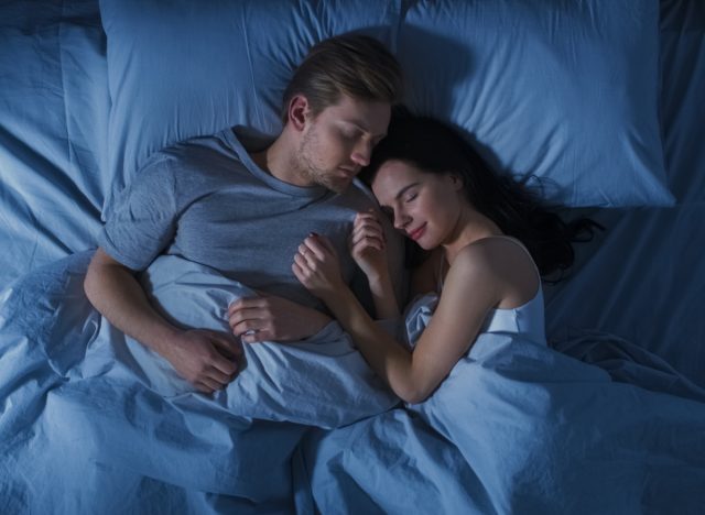 happy couple sleeping peacefully, what happens to your body when you sleep eight hours