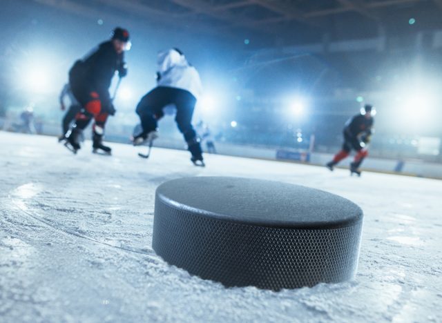 men playing indoor ice hockey