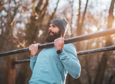 man performing exercises in park to lose 10 pounds in a month