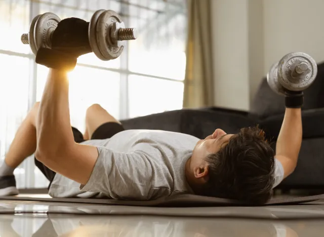 man performing dumbbell chest press to slow down aging after 40