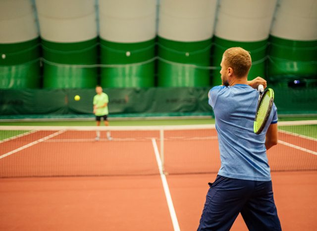 man playing indoor tennis