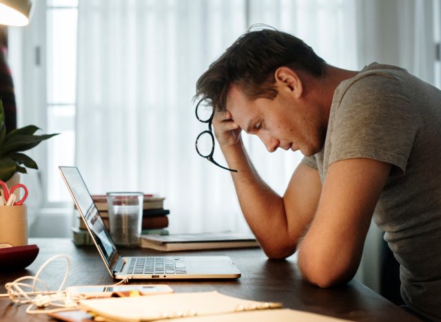 man stressed working on laptop