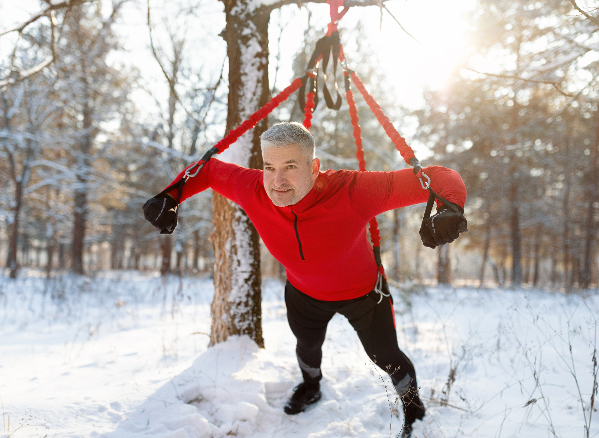 man demonstrates suspension strap workout to get rid of the middle-aged spread