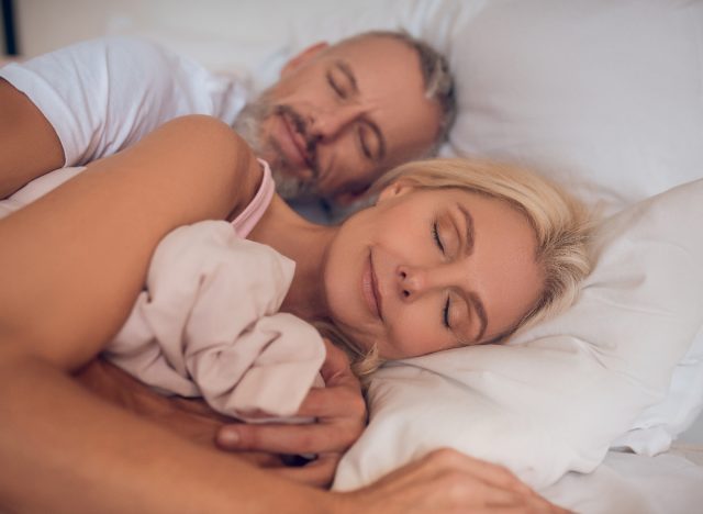 mature couple sleeping peacefully, demonstrating the bedtime habit to slow aging and live longer