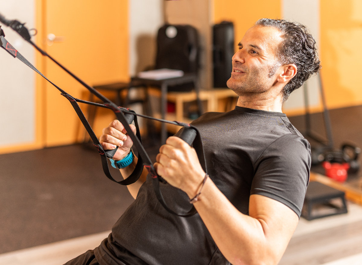 mature man demonstrating suspension strap exercises for stronger muscles in your 50s