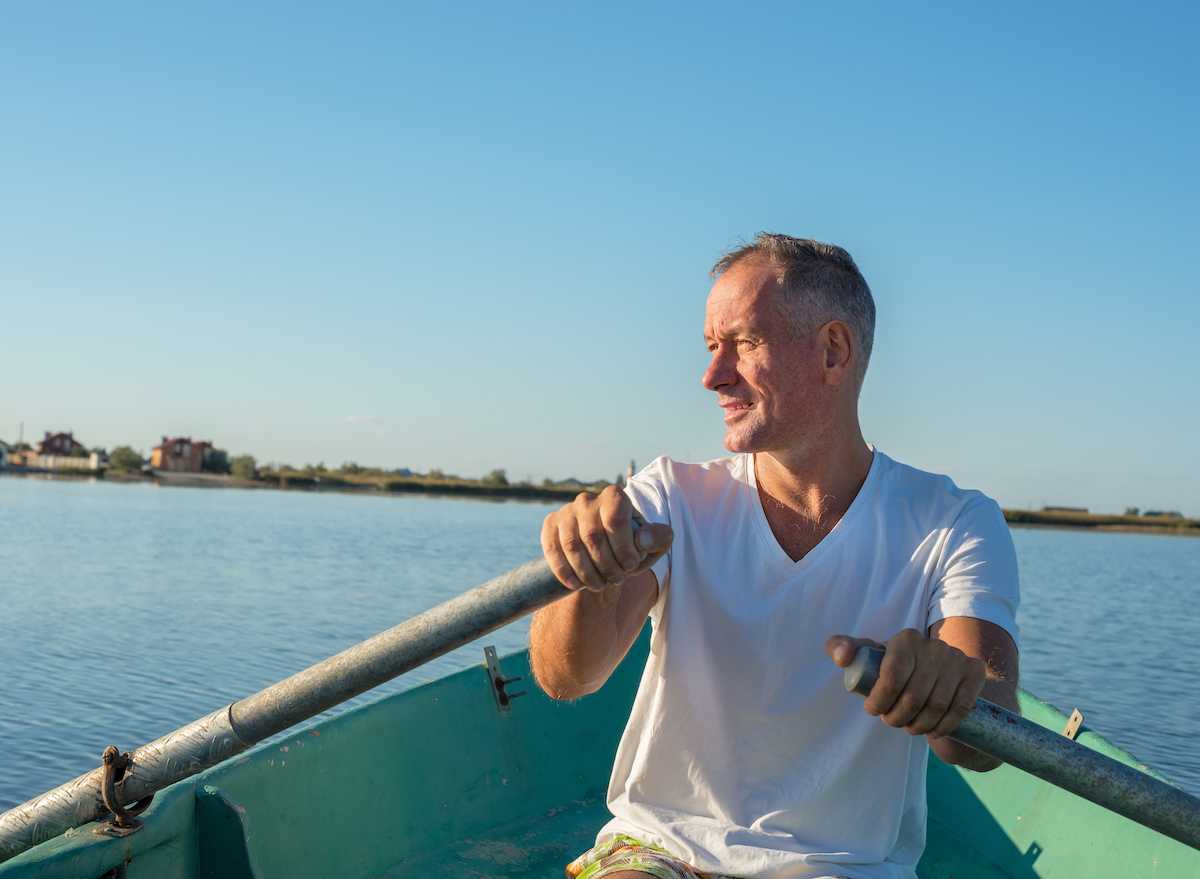 mature man rowing, demonstrating benefits of what rowing does to your body