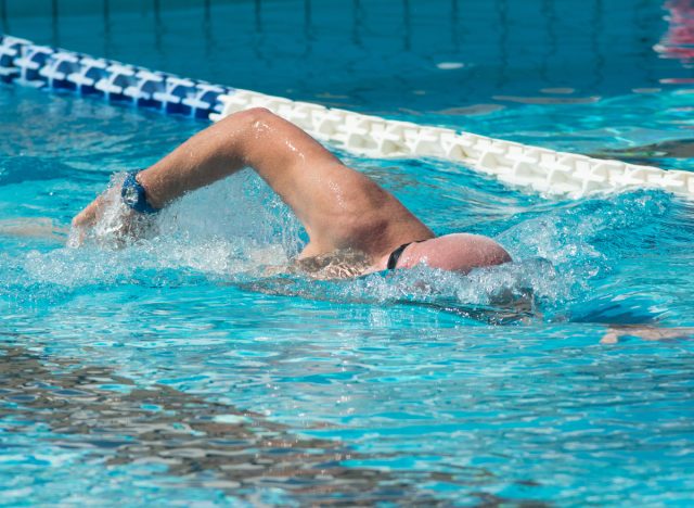 mature man swimming laps part of workout for 60-year-olds