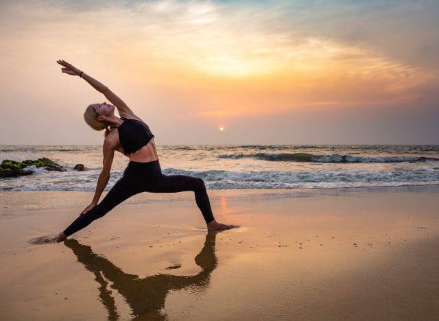 middle-aged woman sunset yoga