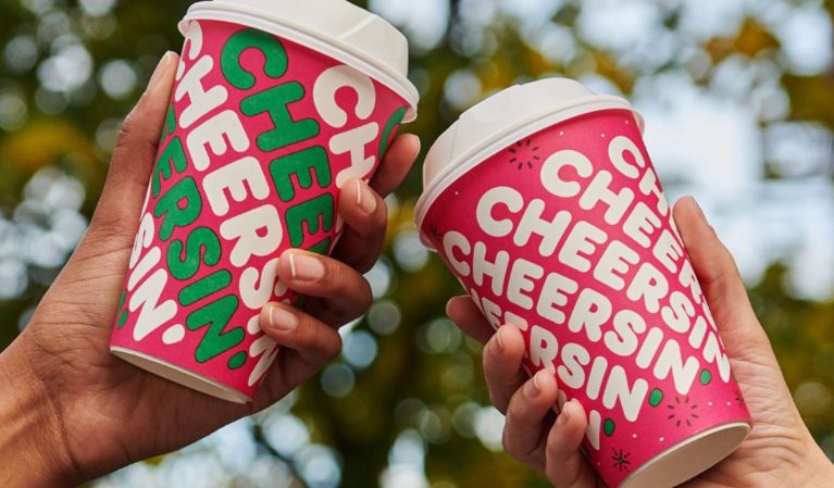 people holding dunkin' holiday cups