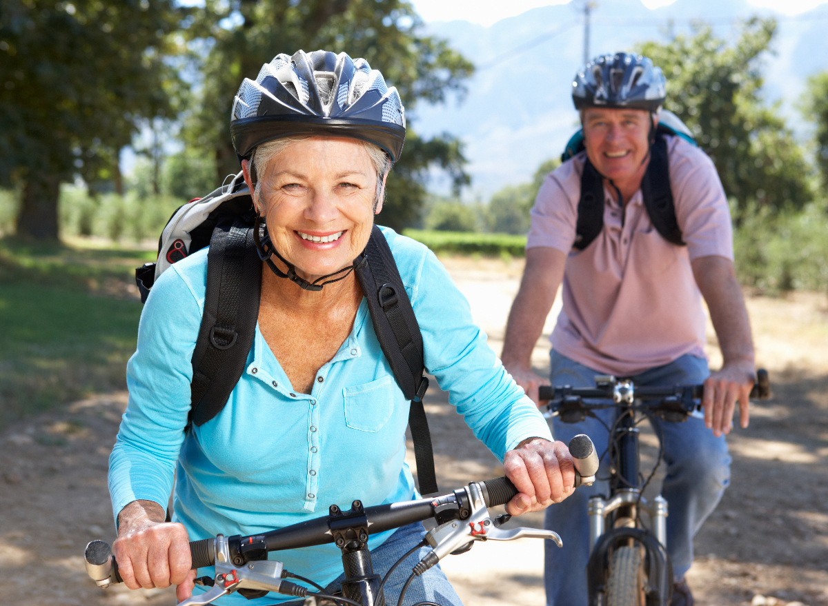 senior biking outdoors, demonstrating exercises to slow down aging in your 60s