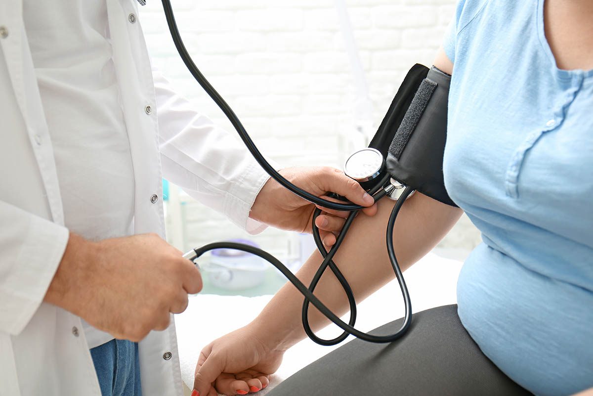 Doctor,Measuring,Blood,Pressure,Of,Overweight,Woman,In,Hospital