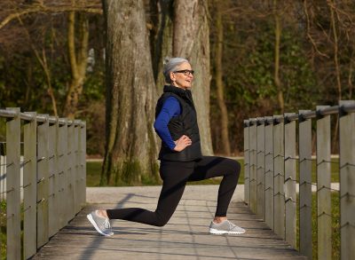 mature woman outdoors performing bodyweight exercises to regain muscle mass after 50