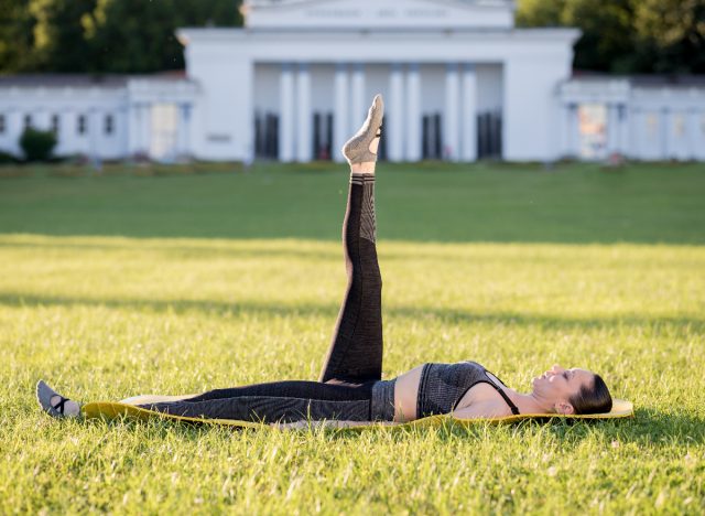 woman performing leg circles Pilates exercise