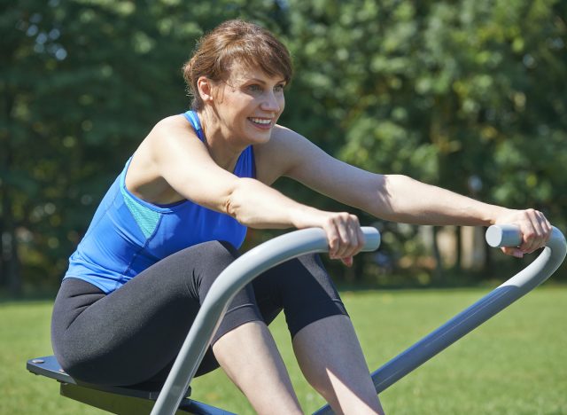woman demonstrating outdoor rowing exercise habits for strong forearms