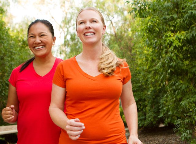two woman walking outdoors, demonstrating the best exercises to help prevent breast cancer